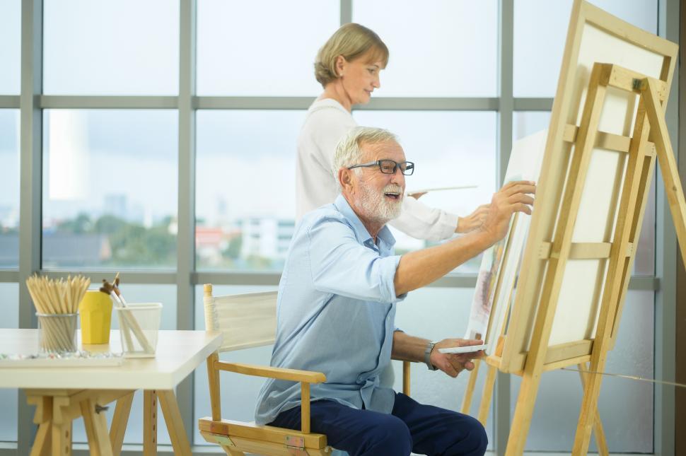 Free Image of Senior citizen couple painting together in home studio 