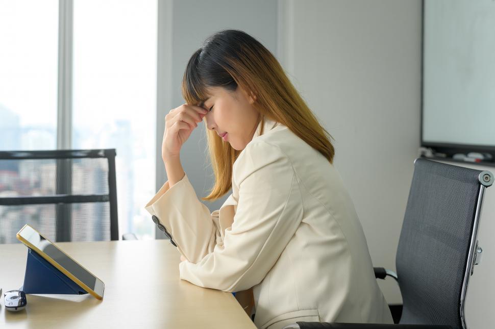 Free Image of Young business Woman stressed and tired in modern office 