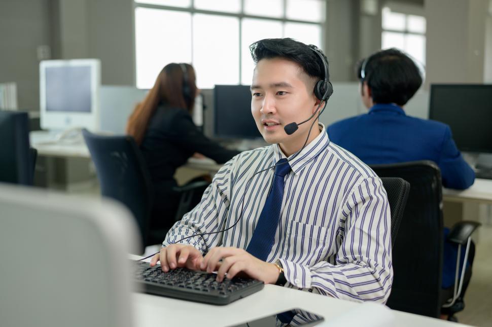 Free Image of Operators are wearing headphone working in customer support center 