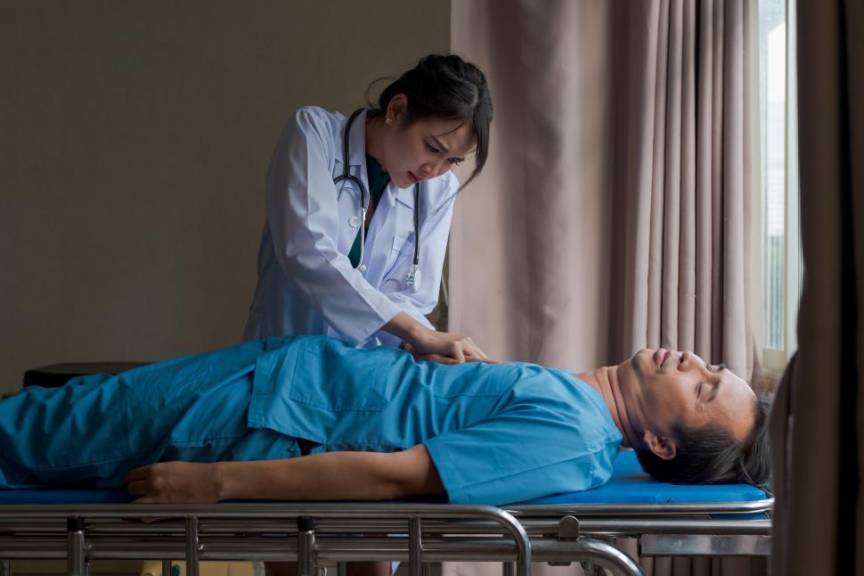 Free Image of Doctor doing cardio pulmonary resuscitation on an unconscious patient 