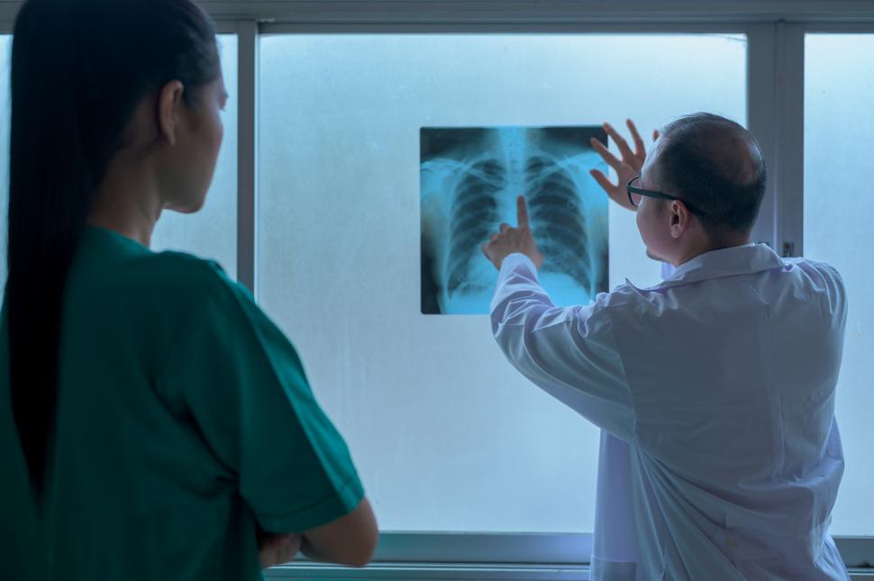 Free Image of The doctor showing X-ray results to patient in provider office 