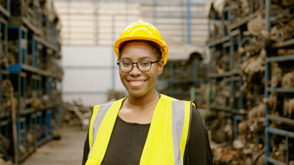 Free Image of portrait of American African woman working in heavy industrial parts area 