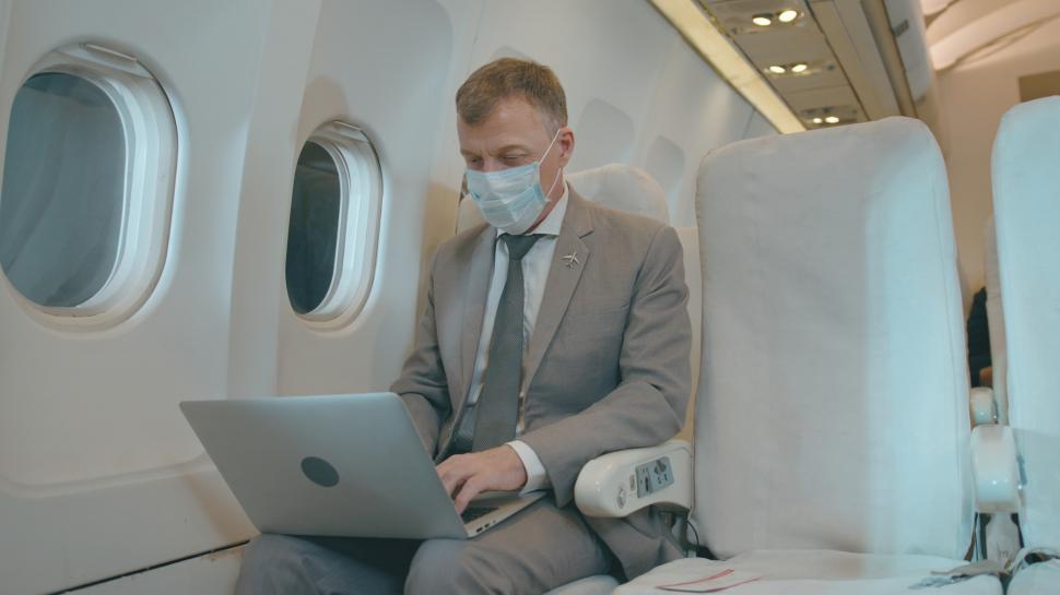 Free Image of A businessman is working with laptop computer in aircraft cabin 