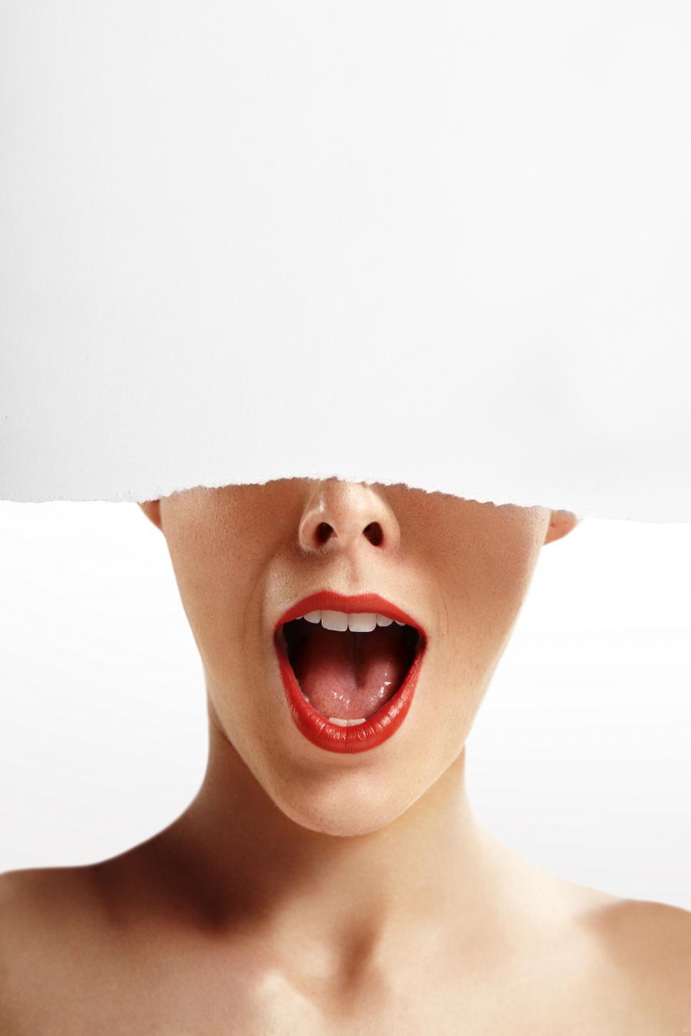 Free Image of Bottom half of a womans face - exclamation as the top is torn off 