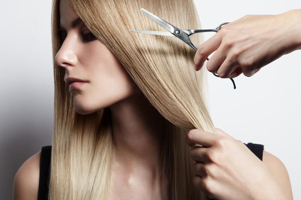 Free Image of woman with long hair a hand holding scissors - hair cutting 