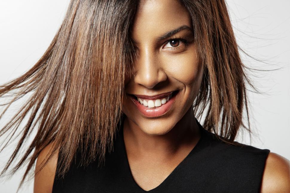 Free Image of smiling black woman with fluttering hair 