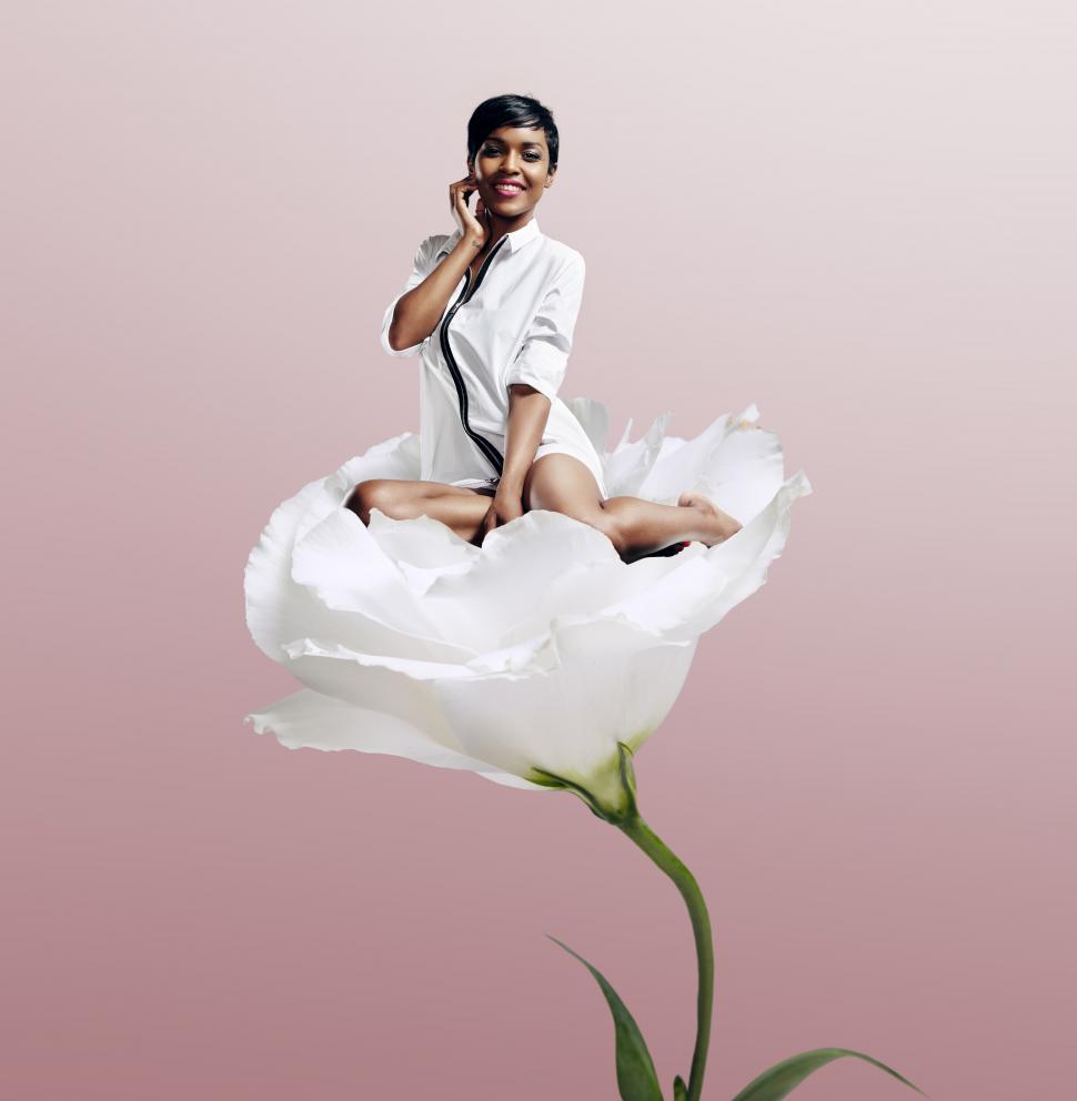 Free Image of black woman sitting on the flower - photo illustration  