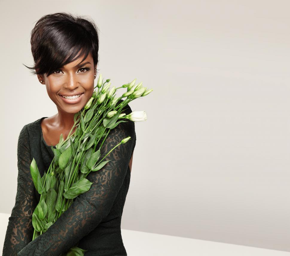 Free Image of black woman holding fresh cut flowers 