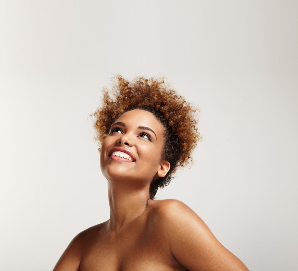 Free Image of happy black girl looking up at blank copyspace above her head 