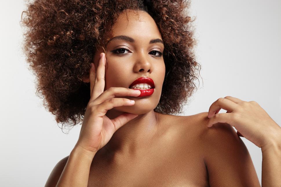 Free Image of portrait of a woman with red lips and afro hair 