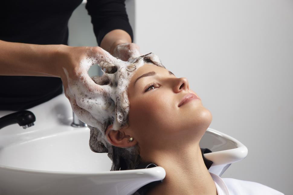 Free Image of woman in salon with hairdresser washing her hair 
