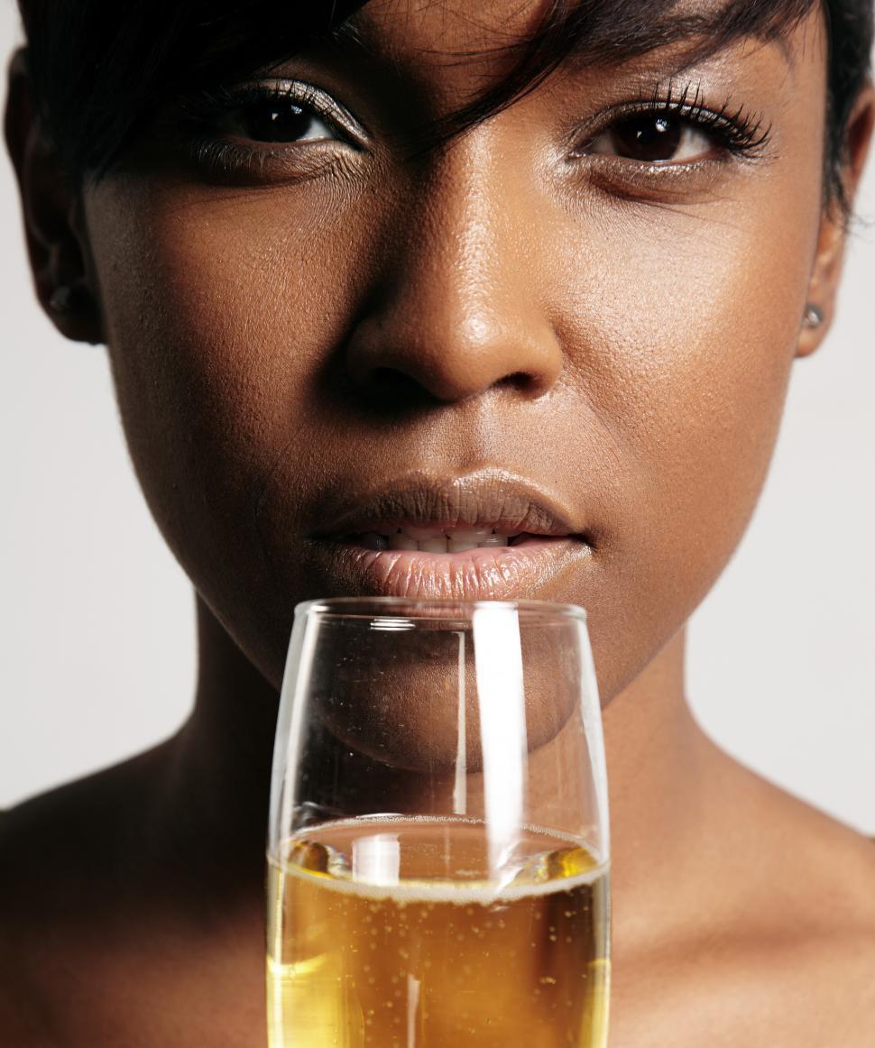 Free Image of closeup portrait of a woman about to drink from a champagne glass 