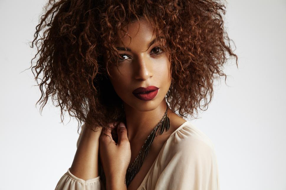 Free Image of Intense black woman with a curly hair and red lips 