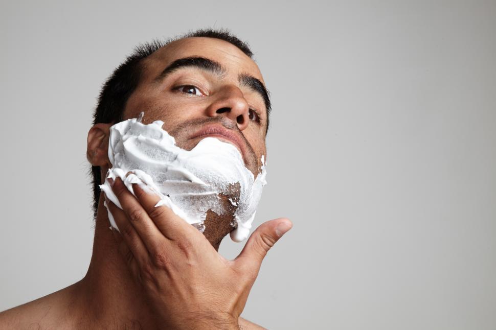 Free Image of man puts a shaviig foam on his neck 