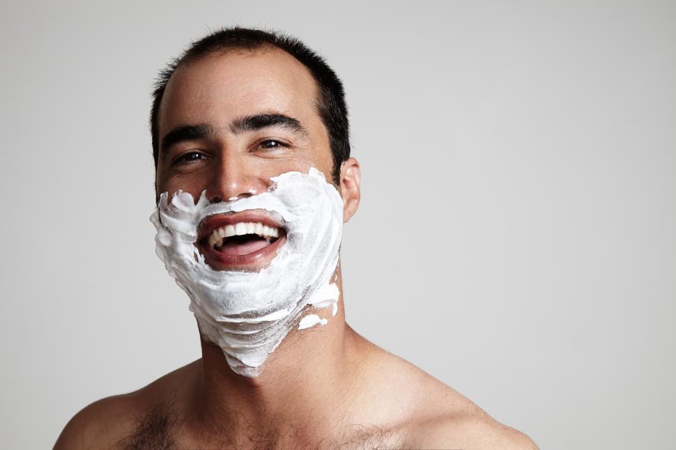Free Image of laughing man with a shaving cream on his face 