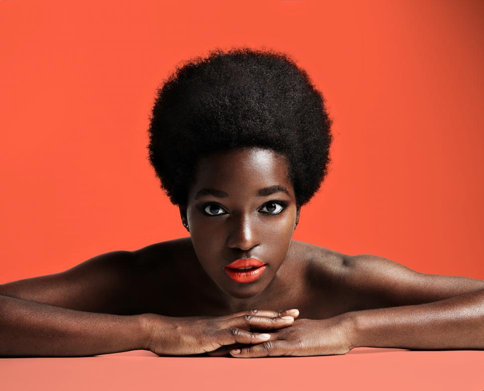 Free Image of pretty black woman with a short afro, on red background 