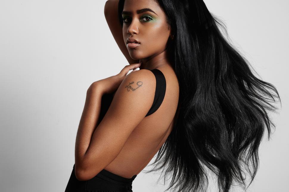 Free Image of beautiful black woman from the side with a blowing hair 