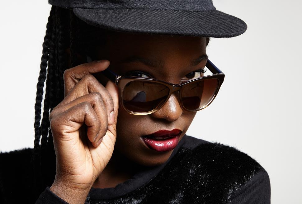 Free Image of closeup black womans eyes watching over lowered sunglasses 