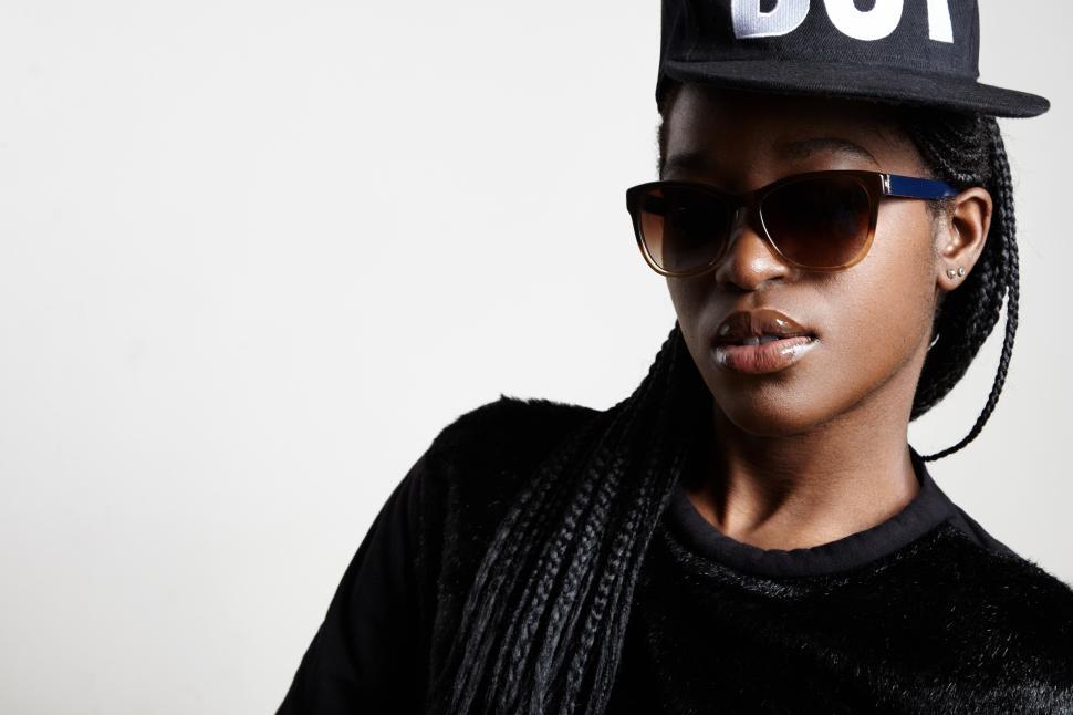 Free Image of black woman swag style in cap and sunglasses 