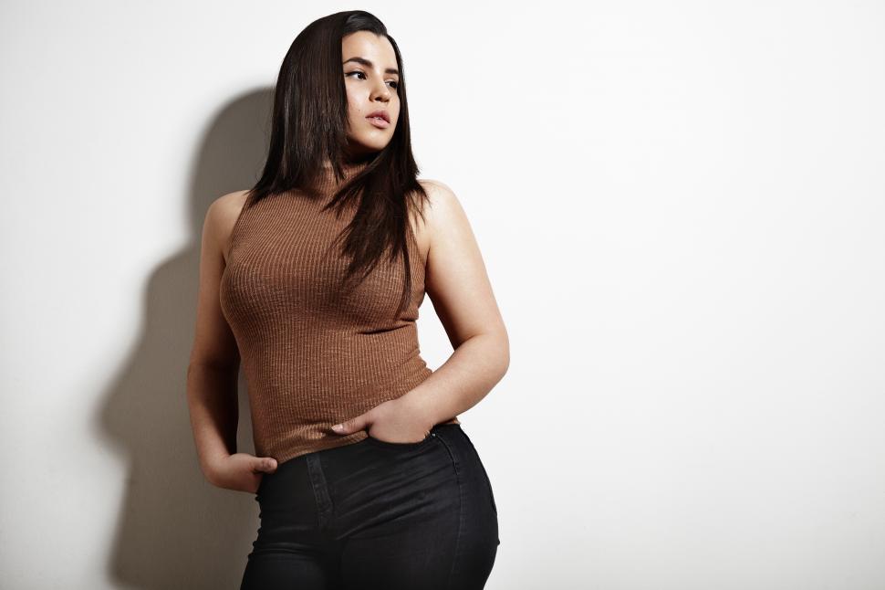 Free Image of plus size model poses on a white background 