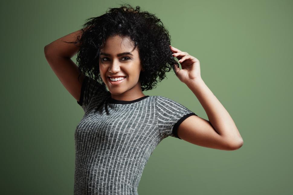 Free Image of happy dancing black woman with arms over head 
