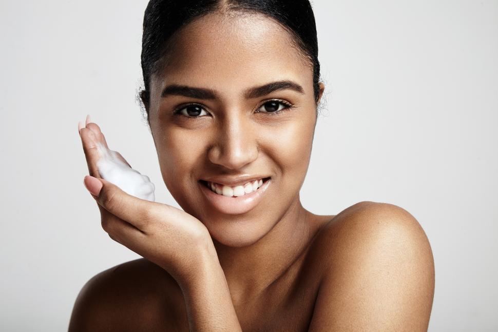 Free Image of cleansing skin concept. smiling woman with a foam on a hand 