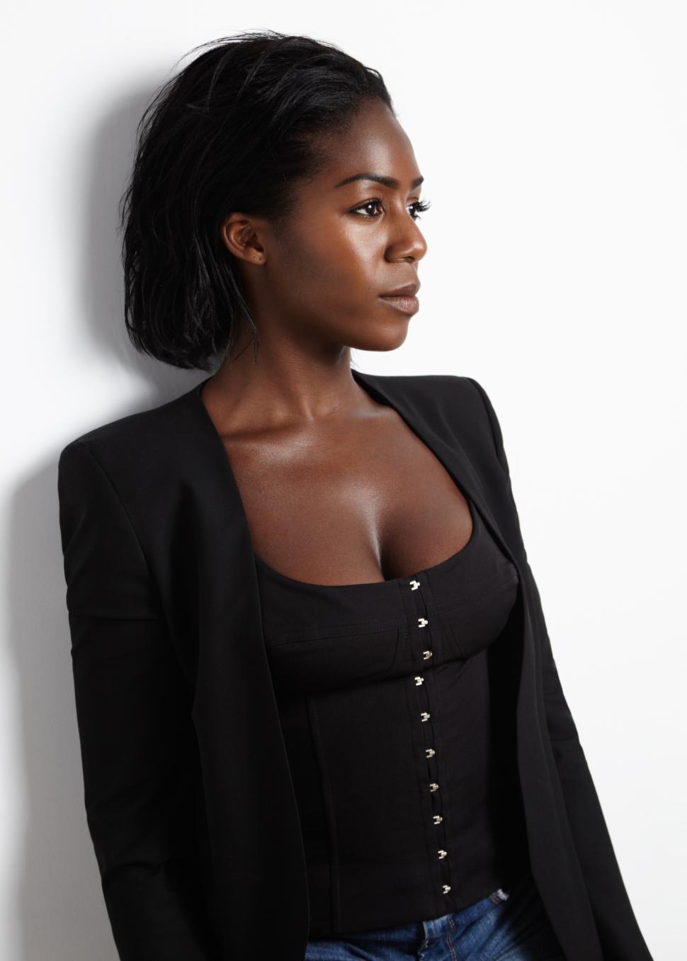 Free Image of beauty black woman in a jacket, shown in profile view 