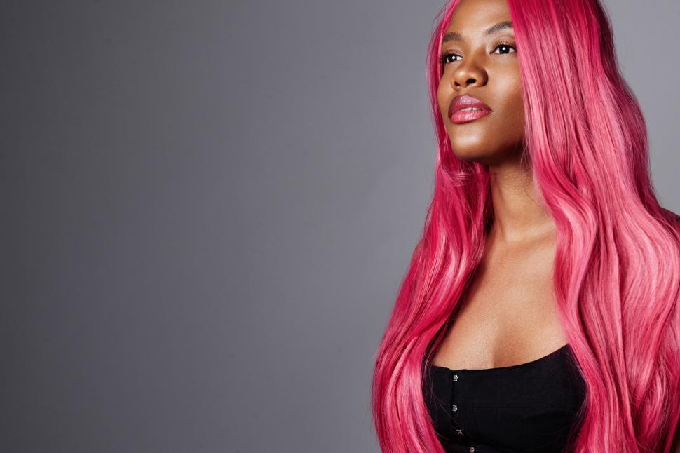 Free Image of gorgeous black woman with bright pink hair. creative hair color concept 