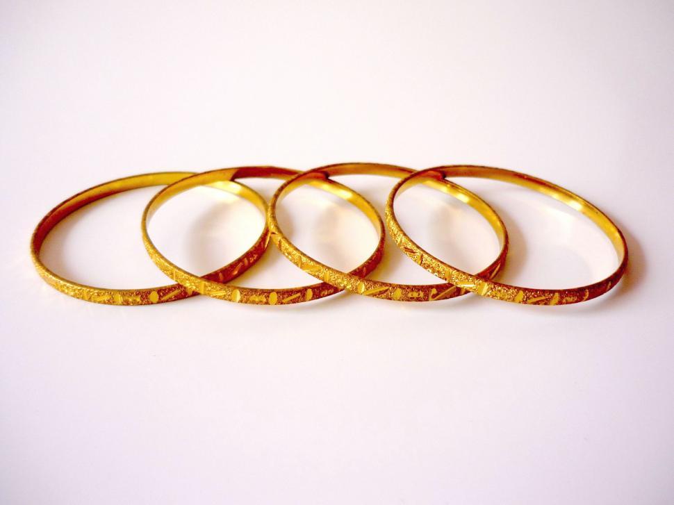 Free Image of Four Gold Rings on White Table 