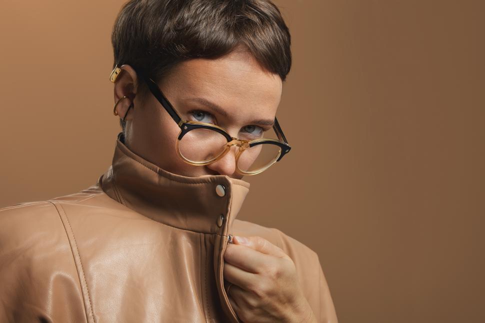 Free Image of Woman with face hidden by tall collar of leather jacket 