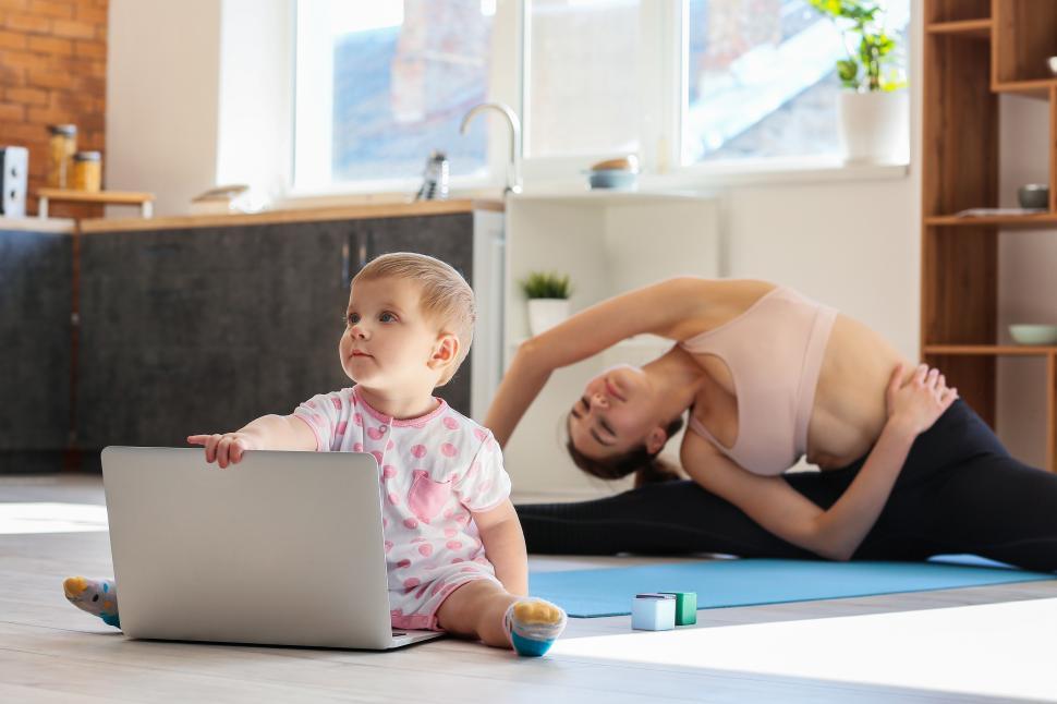 Free Image of A woman and child doing yoga 