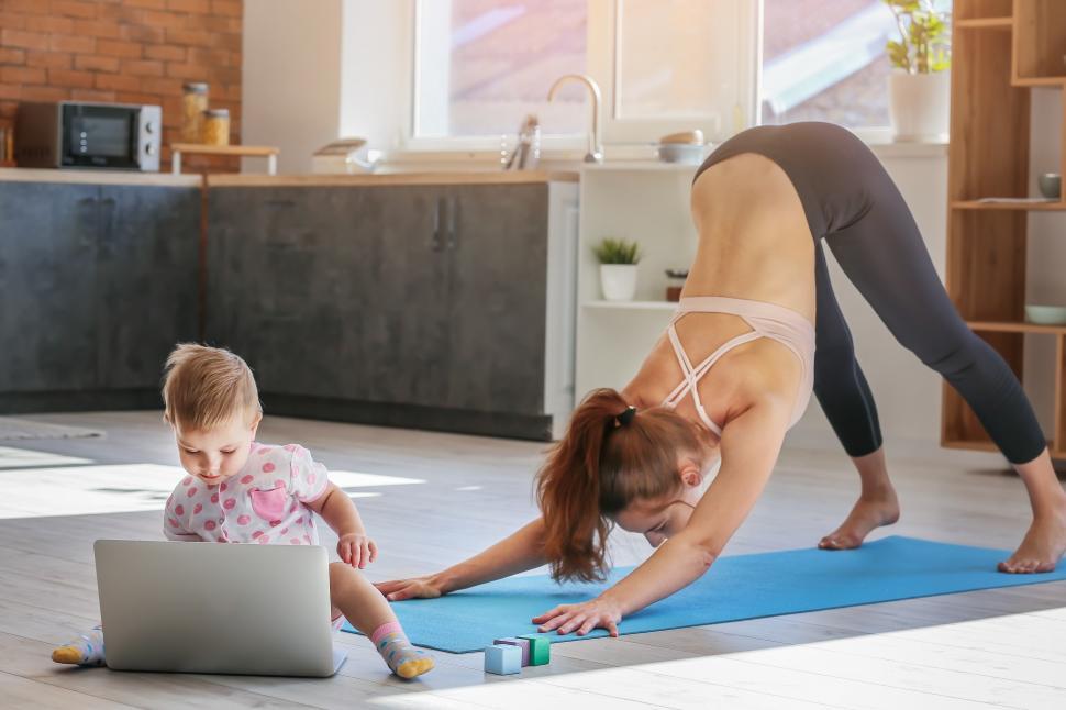 Free Image of A woman and a baby doing yoga 