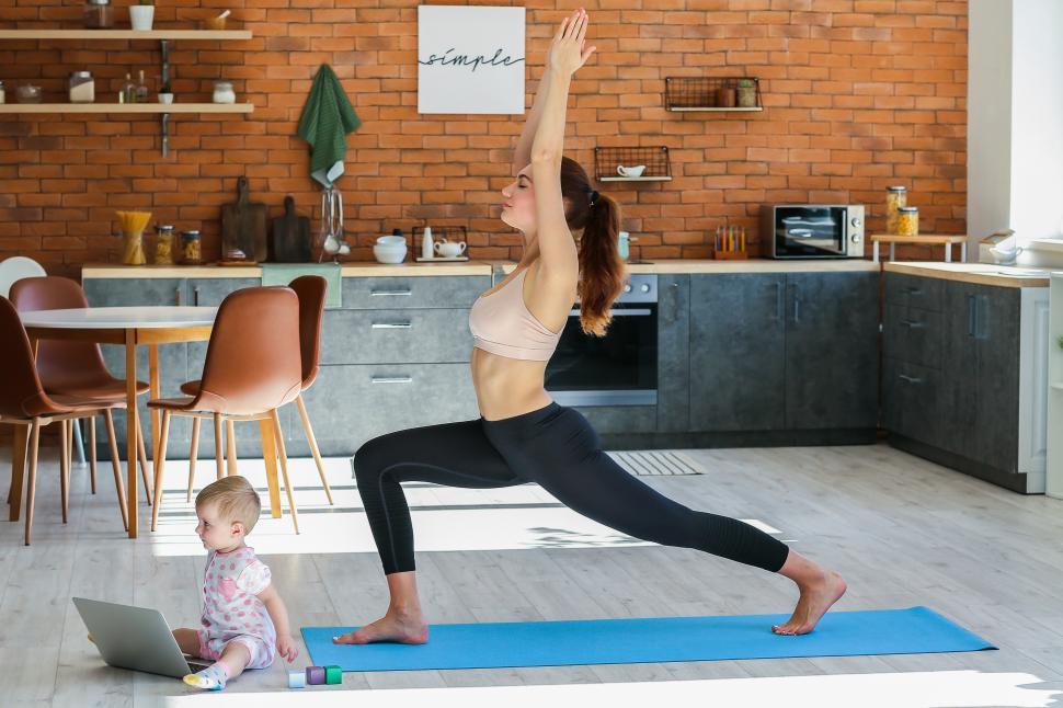 Free Image of A woman doing yoga in a kitchen 