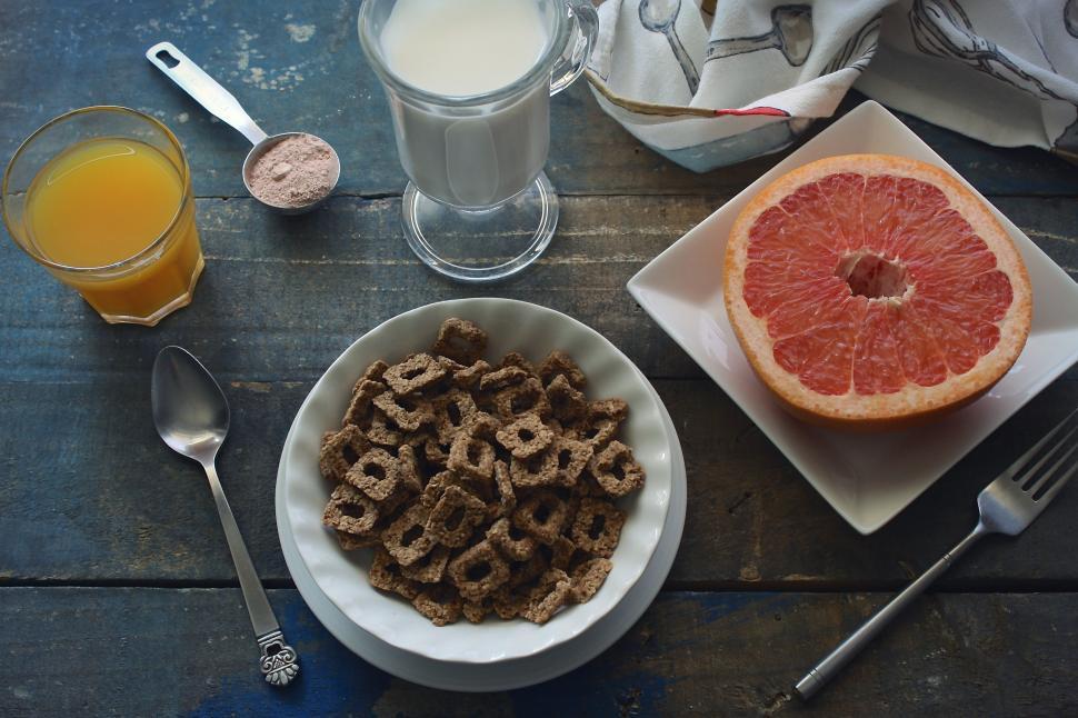 Free Image of A plate of cereal and a grapefruit on a table 