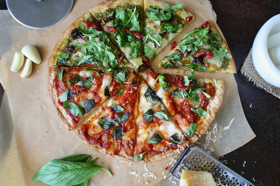 Free Image of A pizza with cheese and basil 