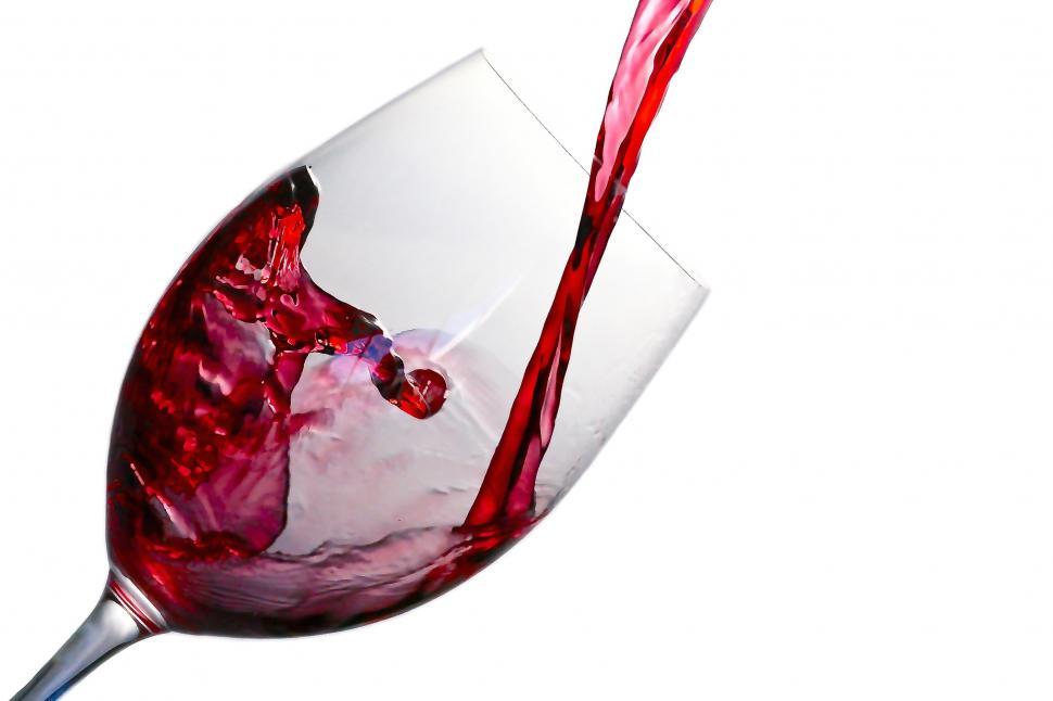 Free Image of A glass of red wine being poured 