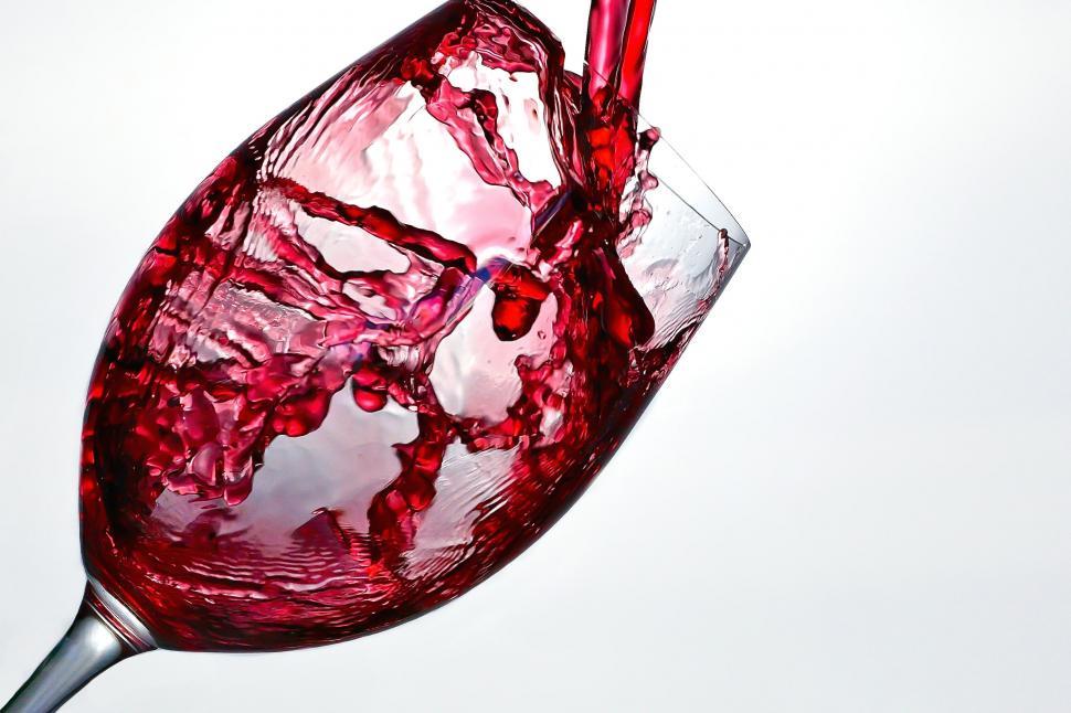 Free Image of A red liquid being poured into a glass 