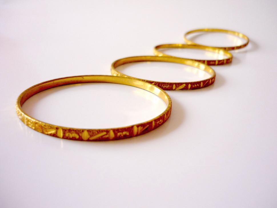 Free Image of Three Gold Rings on White Surface 