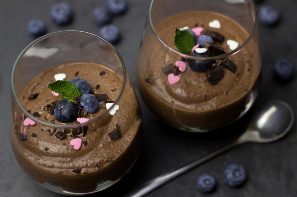 Free Image of Two glasses of chocolate mousse with blueberries and mint leaves 