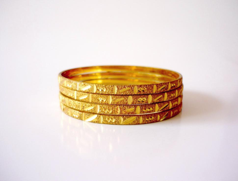 Free Image of Stack of Gold Rings on White Surface 