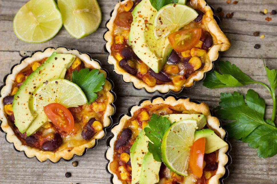 Free Image of A group of small pies with vegetables and fruits 