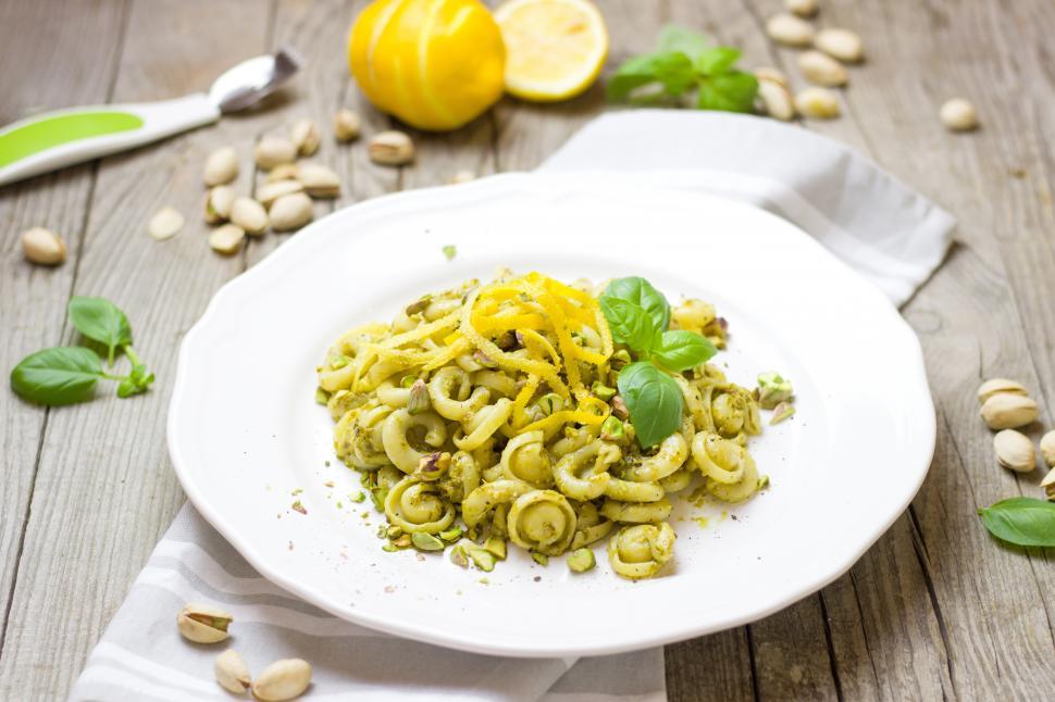Free Image of A plate of pasta with lemons and pistachios 