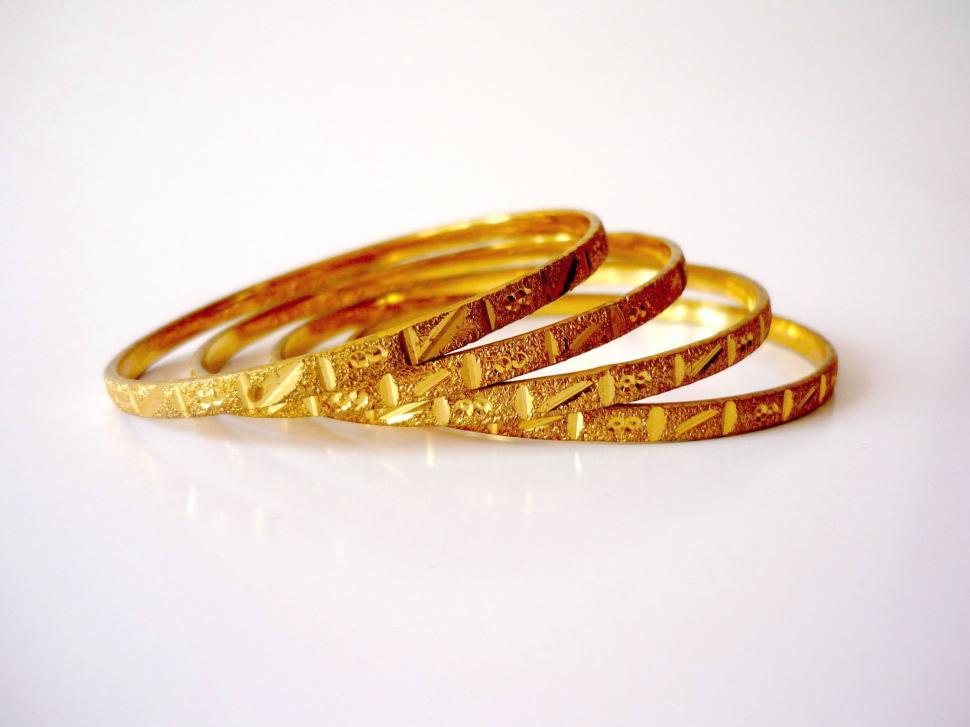 Free Image of Set of Three Gold Rings on White Surface 