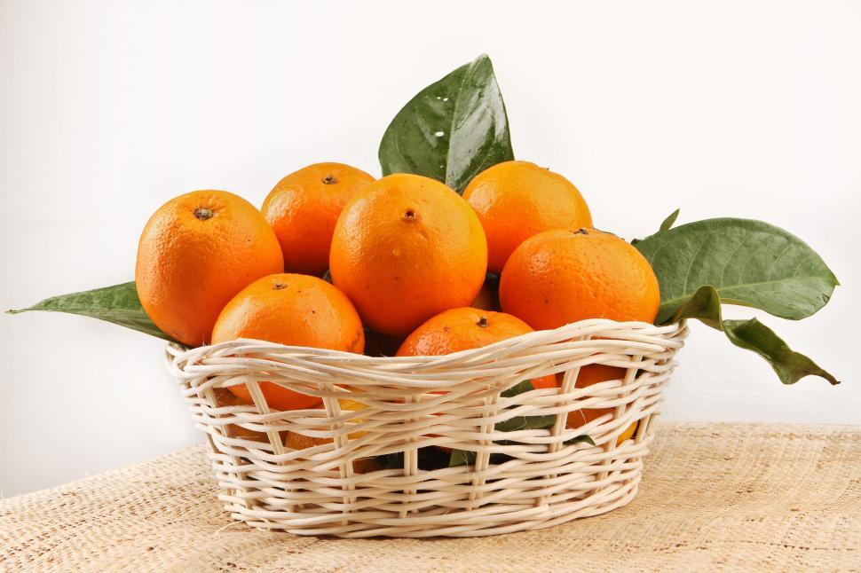 Free Image of A basket of oranges with leaves 