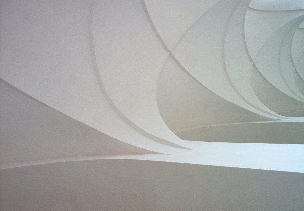 Free Image of A white ceiling with curved lines 