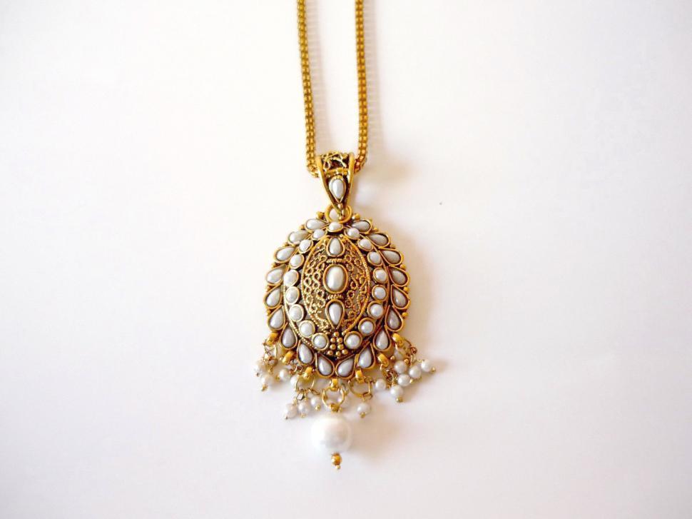 Free Image of Elegant Gold Necklace With Pearls and Tassel 