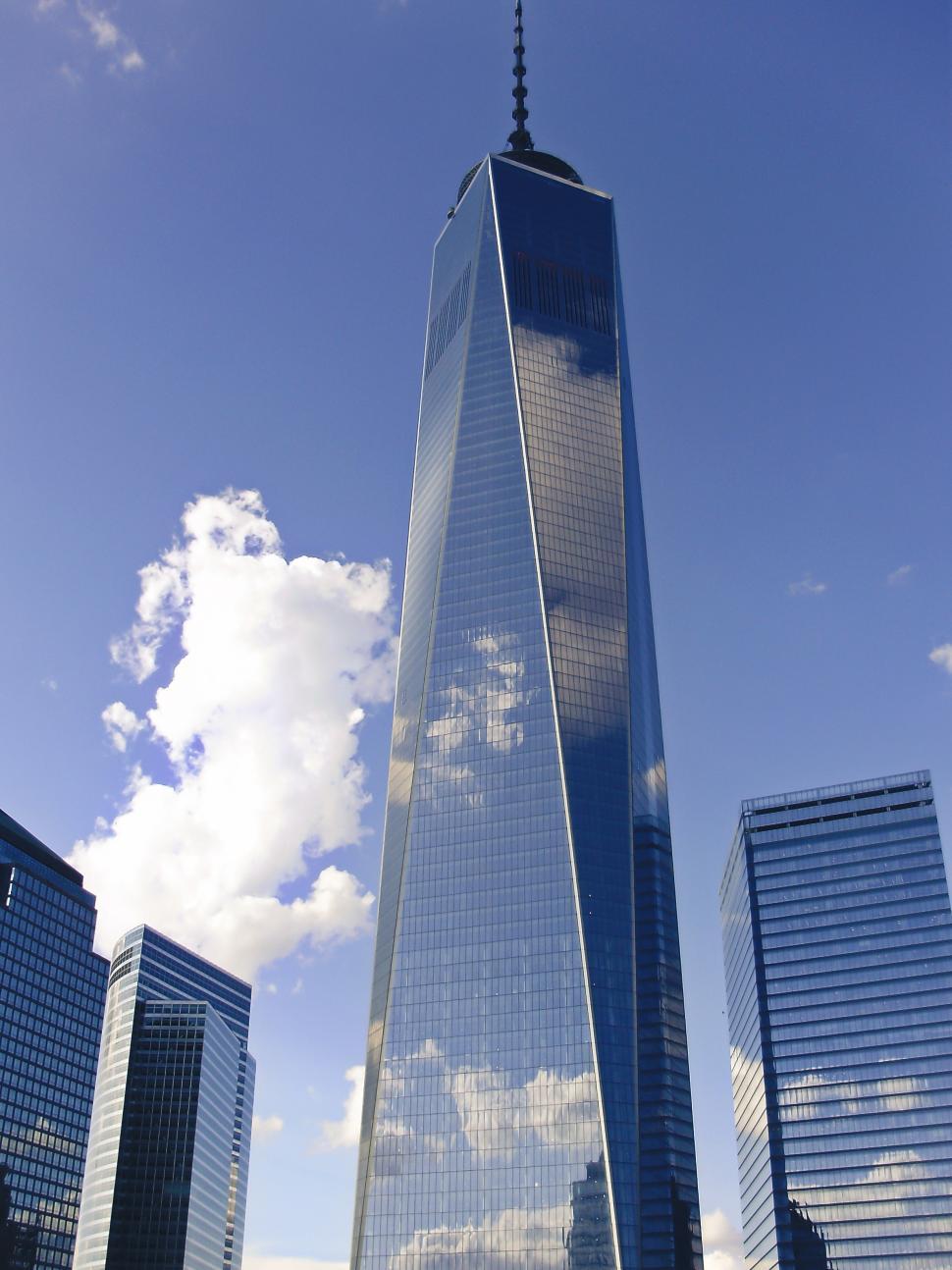 Free Image of A tall glass building with a blue sky 