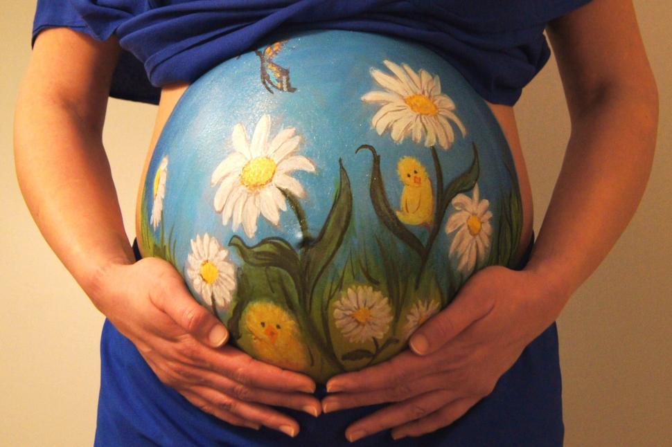 Free Image of A pregnant woman holding her belly 