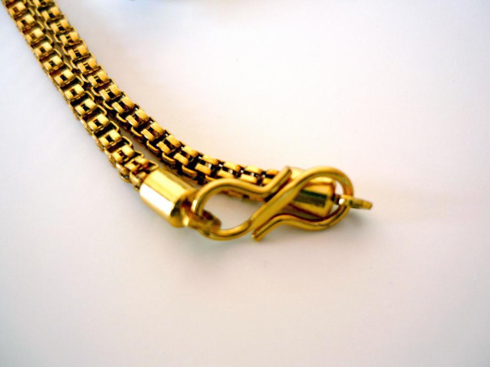 Free Image of Close Up of Gold Necklace on White Surface 