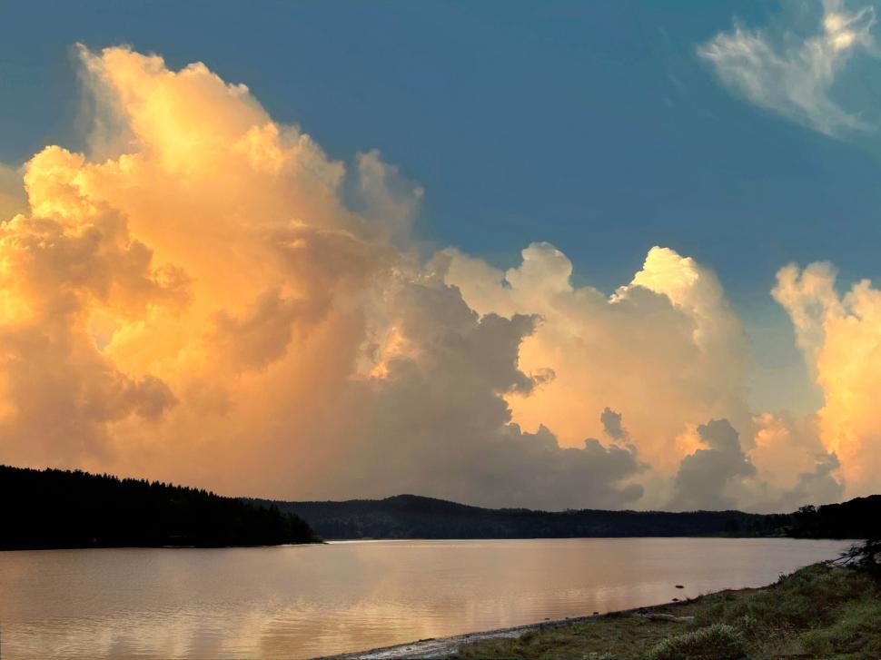 Free Image of A body of water with a body of water and clouds 